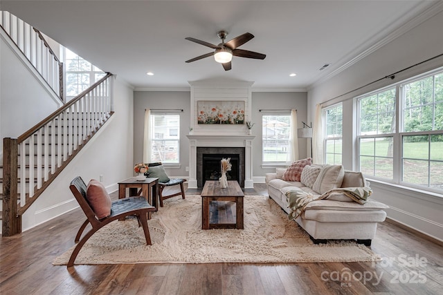 360 Sundown Rd, Mooresville, NC 28117 - living area with baseboards, wood finished floors, a ceiling fan, crown molding, and a tiled fireplace