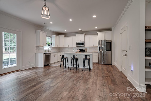 360 Sundown Rd, Mooresville, NC 28117 - kitchen featuring appliances with stainless steel finishes, light countertops, a sink, white cabinetry, and ornamental molding