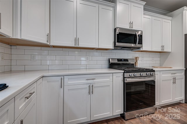 360 Sundown Rd, Mooresville, NC 28117 - kitchen featuring appliances with stainless steel finishes, light countertops, and white cabinets