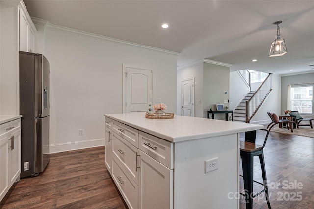 360 Sundown Rd, Mooresville, NC 28117 - kitchen with stainless steel fridge, a breakfast bar, dark wood-style floors, baseboards, and crown molding