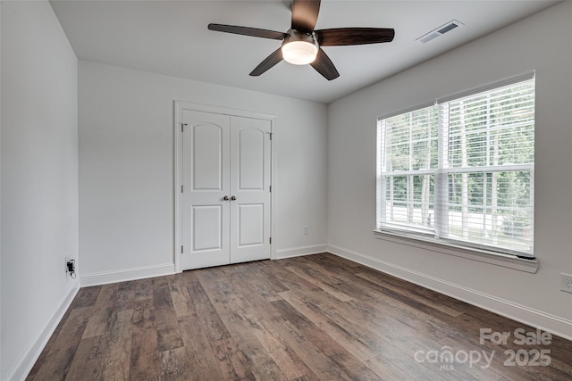 360 Sundown Rd, Mooresville, NC 28117 - unfurnished bedroom featuring wood finished floors, baseboards, a closet, and ceiling fan