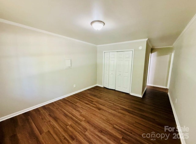 1583 Green Circle Dr, Gastonia, NC 28054 - unfurnished bedroom featuring crown molding, dark wood-style floors, and a closet