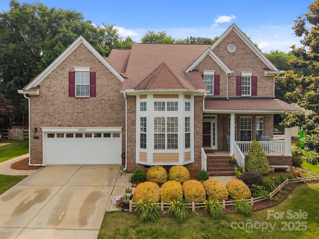 10703 Back Ridge Rd, Charlotte, NC 28277 - traditional home featuring concrete driveway, a porch, an attached garage, and brick siding