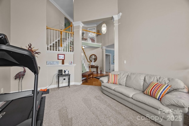 10703 Back Ridge Rd, Charlotte, NC 28277 - carpeted living room featuring ornate columns, stairs, a high ceiling, crown molding, and baseboards