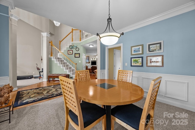 10703 Back Ridge Rd, Charlotte, NC 28277 - dining area featuring carpet, ornate columns, a wainscoted wall, stairs, and crown molding