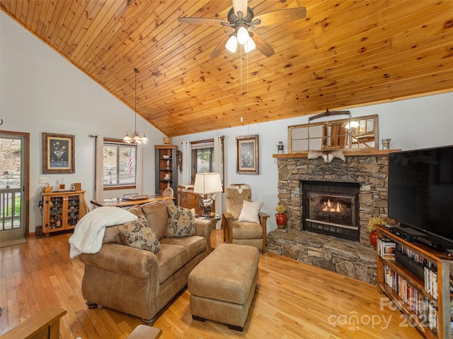 141 Creekside Dr, Maggie Valley, NC 28751 - living area featuring a stone fireplace, hardwood / wood-style floors, high vaulted ceiling, a chandelier, and ceiling fan