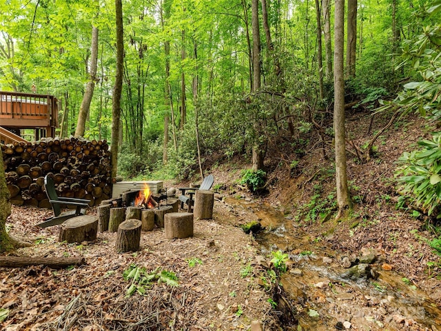 141 Creekside Dr, Maggie Valley, NC 28751 - view of yard featuring an outdoor fire pit and a view of trees