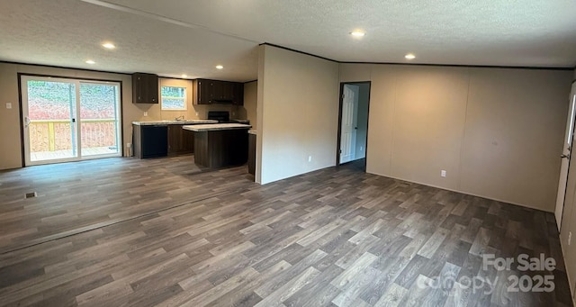 3162 Bear Trail Dr, Lenoir, NC 28645 - kitchen featuring open floor plan, wood finished floors, light countertops, a textured ceiling, and a center island