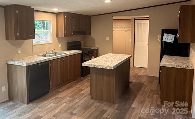 3162 Bear Trail Dr, Lenoir, NC 28645 - kitchen featuring black appliances, a sink, light wood-style flooring, light countertops, and a textured ceiling