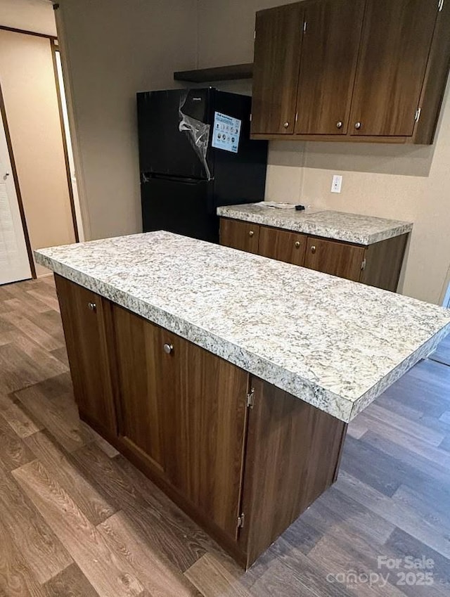 3162 Bear Trail Dr, Lenoir, NC 28645 - kitchen with freestanding refrigerator, dark wood finished floors, light countertops, and dark brown cabinets
