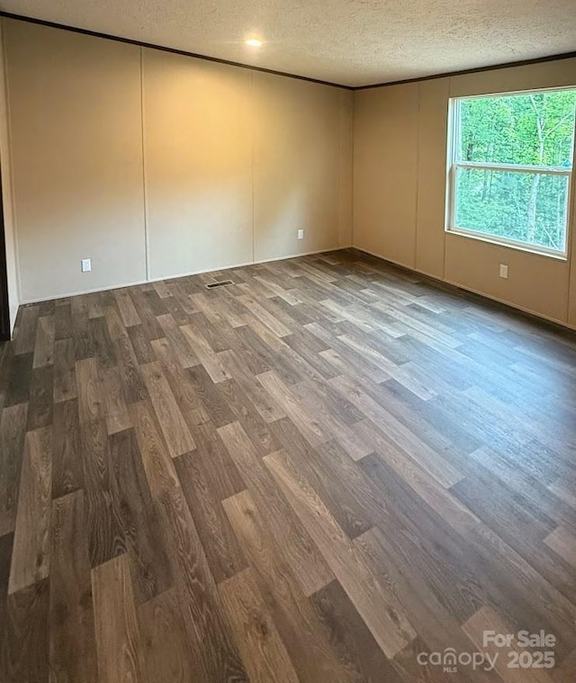 3162 Bear Trail Dr, Lenoir, NC 28645 - spare room featuring a textured ceiling and wood finished floors