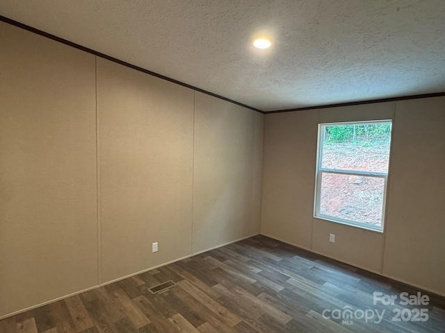 3162 Bear Trail Dr, Lenoir, NC 28645 - unfurnished room featuring crown molding, dark wood finished floors, a textured ceiling, and a decorative wall
