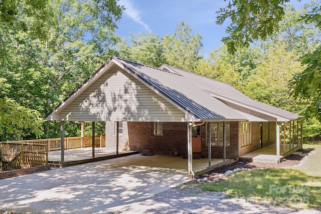 3090 Goblet Rd, Richburg, SC 29729 - view of front of house featuring concrete driveway, brick siding, metal roof, and a porch