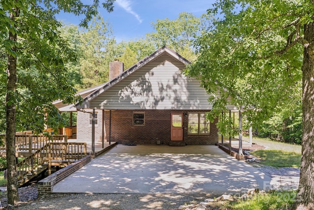 3090 Goblet Rd, Richburg, SC 29729 - rear view of property with a chimney, driveway, a deck, a patio area, and brick siding