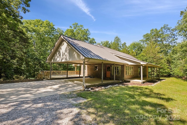 3090 Goblet Rd, Richburg, SC 29729 - view of front of home with concrete driveway, an attached carport, a front yard, metal roof, and brick siding