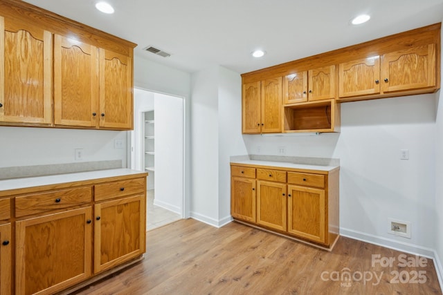 3090 Goblet Rd, Richburg, SC 29729 - kitchen with light countertops, light wood-style floors, baseboards, recessed lighting, and brown cabinets