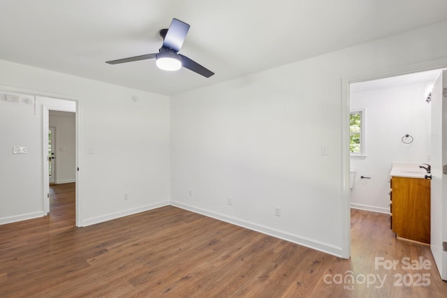 3090 Goblet Rd, Richburg, SC 29729 - unfurnished bedroom featuring wood finished floors, baseboards, a sink, and ceiling fan