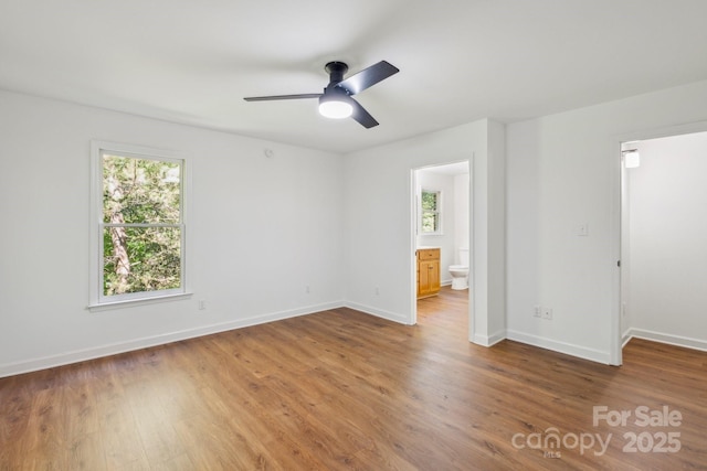 3090 Goblet Rd, Richburg, SC 29729 - unfurnished bedroom featuring wood finished floors, baseboards, a walk in closet, and ensuite bathroom