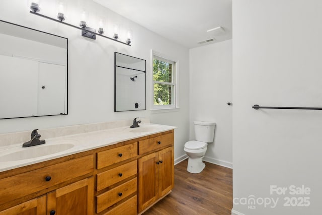 3090 Goblet Rd, Richburg, SC 29729 - full bathroom with toilet, double vanity, wood finished floors, baseboards, and a shower