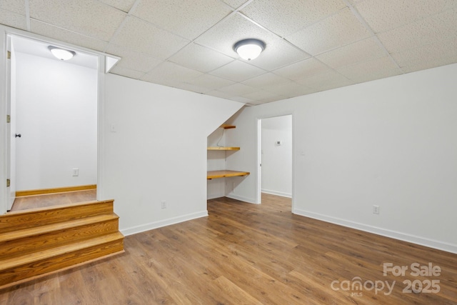 3090 Goblet Rd, Richburg, SC 29729 - below grade area featuring wood finished floors, baseboards, a drop ceiling, and stairs
