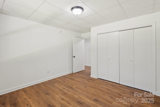 3090 Goblet Rd, Richburg, SC 29729 - unfurnished bedroom with a drop ceiling, wood finished floors, a closet, and baseboards