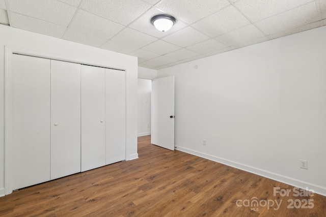 3090 Goblet Rd, Richburg, SC 29729 - unfurnished bedroom featuring a drop ceiling, baseboards, a closet, and wood finished floors