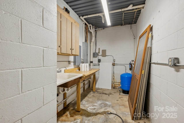 3090 Goblet Rd, Richburg, SC 29729 - unfinished below grade area featuring a water pressure tank, a sink, and concrete block wall