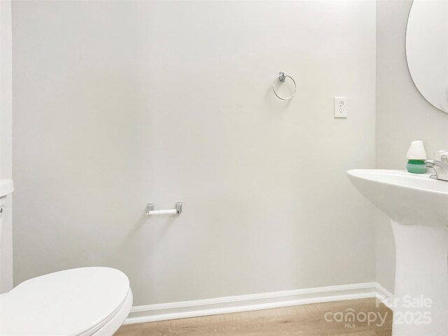 14123 Tranters Creek Ln, Charlotte, NC 28273 - bathroom featuring toilet, baseboards, and a sink