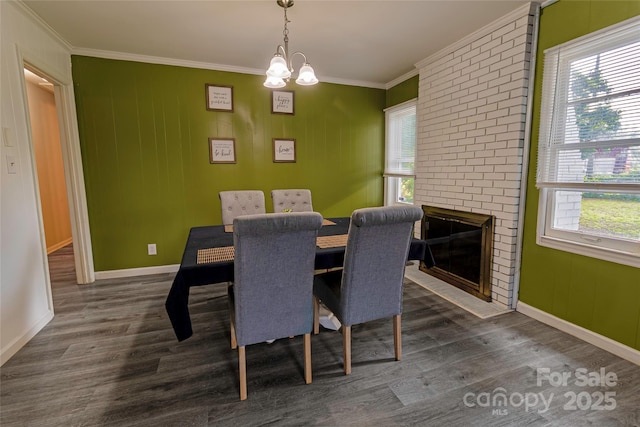 901 Echo Glen Rd, Charlotte, NC 28213 - dining area with crown molding, dark wood-type flooring, baseboards, a chandelier, and a brick fireplace