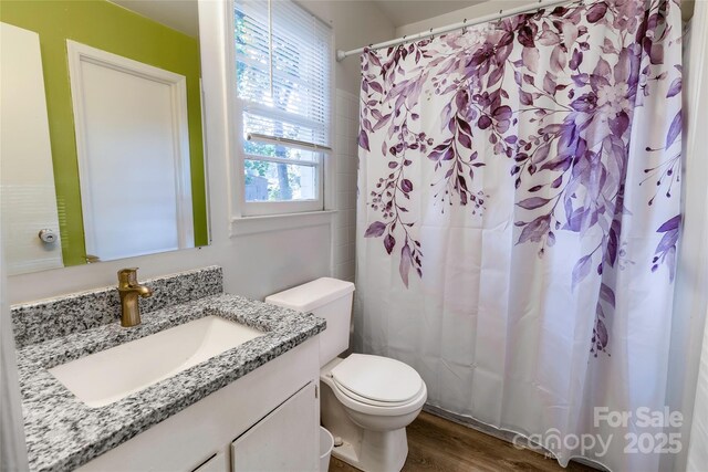 901 Echo Glen Rd, Charlotte, NC 28213 - bathroom with toilet, vanity, wood finished floors, and a shower with shower curtain