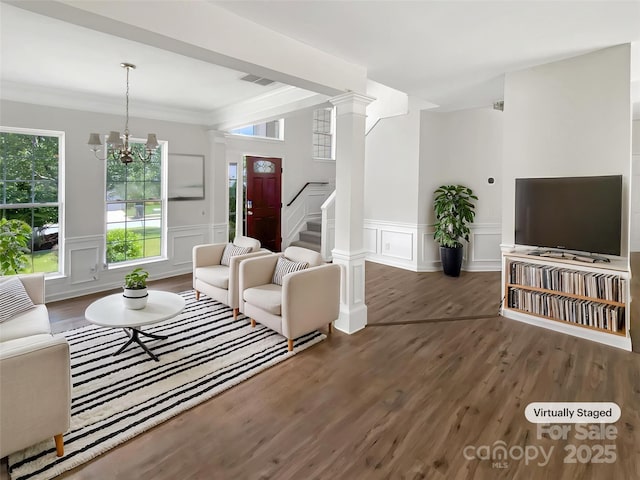 6413 Fillian Ln, Charlotte, NC 28269 - living room with a decorative wall, wood finished floors, stairway, a chandelier, and a wainscoted wall