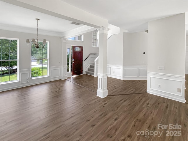 6413 Fillian Ln, Charlotte, NC 28269 - foyer entrance with a decorative wall, stairs, a chandelier, dark wood-style flooring, and crown molding
