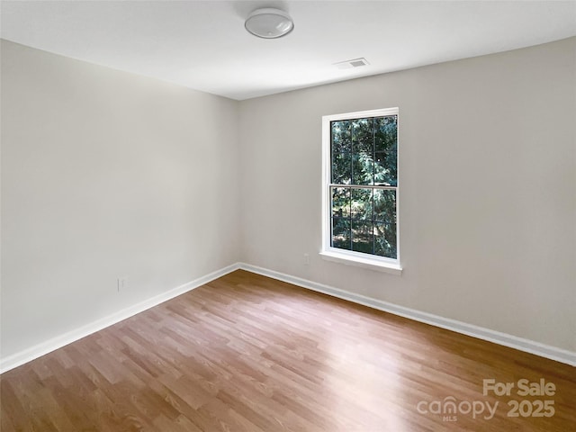 6413 Fillian Ln, Charlotte, NC 28269 - empty room featuring wood finished floors and baseboards