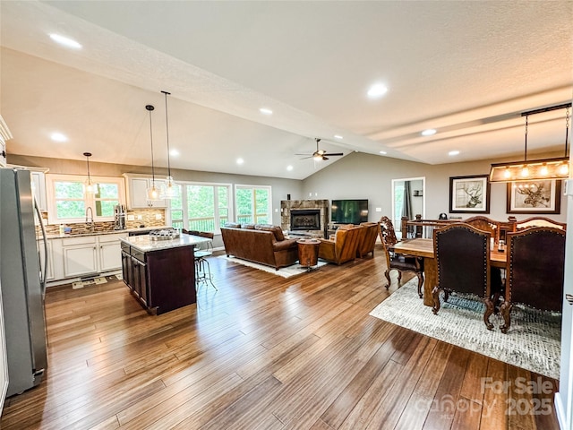 171 View Ridge Parkway, Leicester, NC 28748 - dining space with a glass covered fireplace, ceiling fan, vaulted ceiling, wood finished floors, and recessed lighting