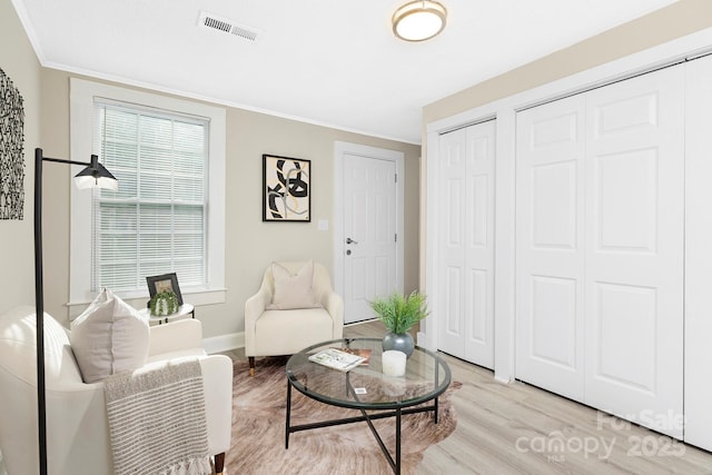 210 E 5th Ave, Gastonia, NC 28054 - living room featuring light wood finished floors, ornamental molding, and baseboards