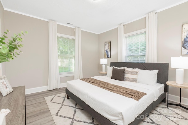 210 E 5th Ave, Gastonia, NC 28054 - bedroom featuring light wood-style floors, crown molding, and baseboards