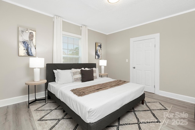 210 E 5th Ave, Gastonia, NC 28054 - bedroom with light wood-style flooring, crown molding, and baseboards