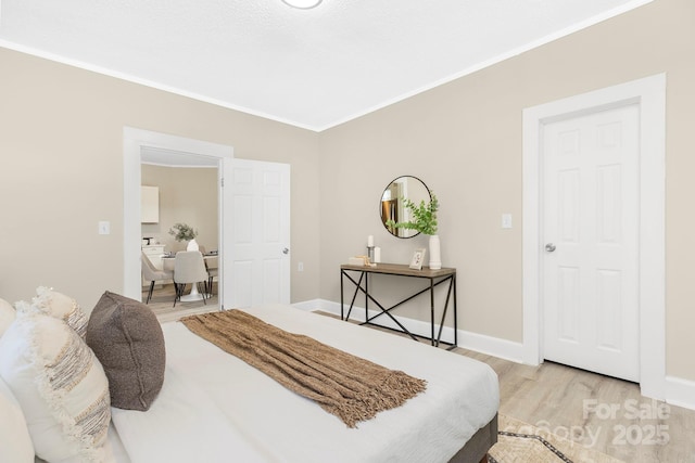 210 E 5th Ave, Gastonia, NC 28054 - bedroom with light wood-type flooring, ornamental molding, and baseboards