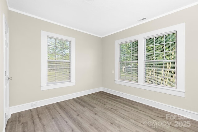 210 E 5th Ave, Gastonia, NC 28054 - empty room with crown molding, wood finished floors, and baseboards