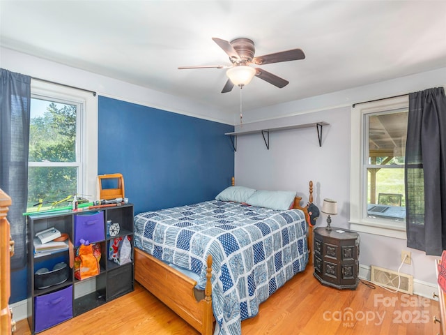 78 Hardin Ln, Clyde, NC 28721 - bedroom featuring wood finished floors and ceiling fan