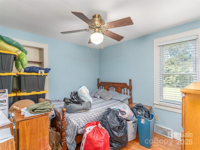 78 Hardin Ln, Clyde, NC 28721 - bedroom featuring multiple windows, wood finished floors, a ceiling fan, and baseboards
