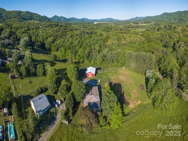 78 Hardin Ln, Clyde, NC 28721 - aerial view of property and surrounding area featuring a heavily wooded area and a mountainous background