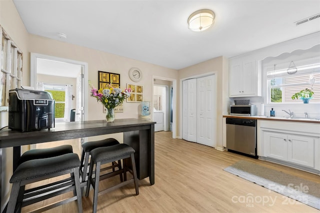 122 Pratt St, Belmont, NC 28012 - kitchen with stainless steel appliances, a sink, white cabinetry, and light wood-style floors