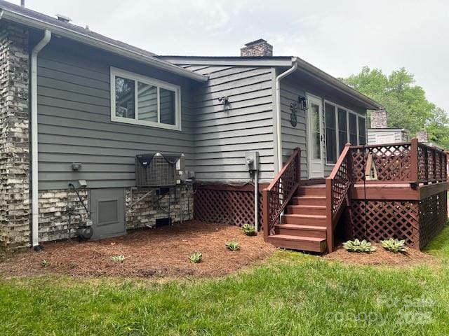 205 Wellington Hills Cir Unit 205, Salisbury, NC 28147 - back of property with a wooden deck, a chimney, a yard, and stairs