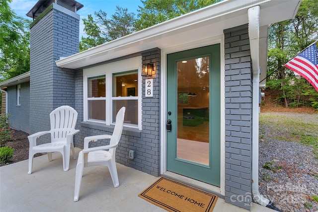 28 Reynolds School Rd, Asheville, NC 28803 - view of exterior entry featuring a chimney and brick siding