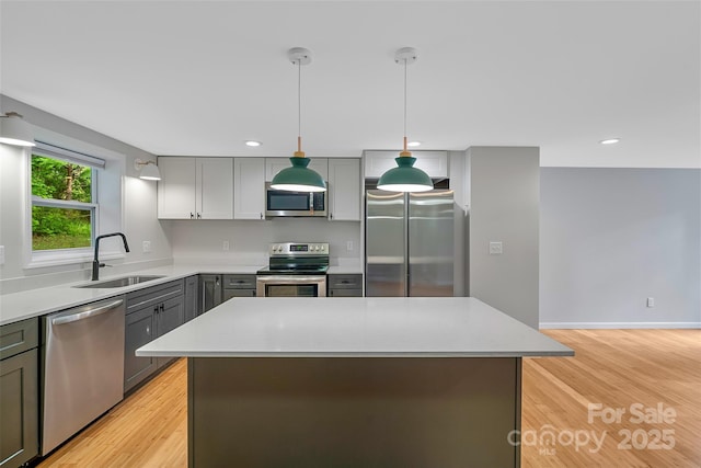 28 Reynolds School Rd, Asheville, NC 28803 - kitchen featuring stainless steel appliances, a sink, gray cabinets, light countertops, and decorative light fixtures