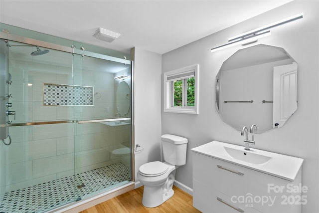 28 Reynolds School Rd, Asheville, NC 28803 - full bath featuring toilet, wood finished floors, vanity, and a shower stall