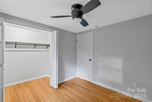 28 Reynolds School Rd, Asheville, NC 28803 - unfurnished bedroom with light wood finished floors, baseboards, a ceiling fan, and a closet