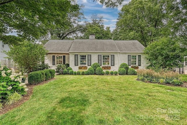 829 Sedgefield Rd, Charlotte, NC 28209 - view of front of home with brick siding, a front yard, a chimney, and a shingled roof