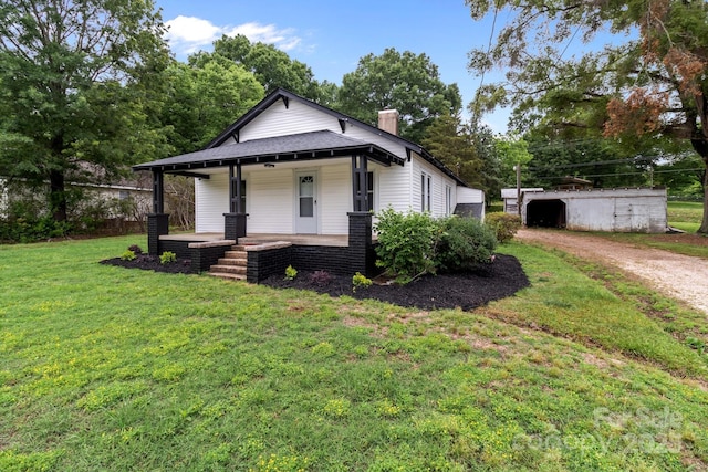 1406 Upper Enochville Rd, Kannapolis, NC 28081 - view of front of house with a porch, a chimney, a front yard, and driveway
